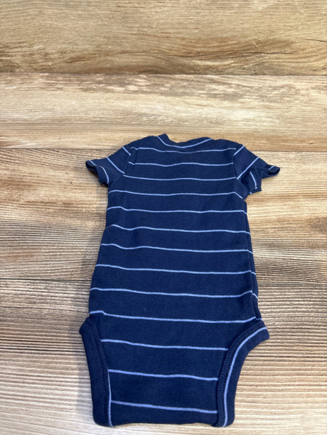 Flat view of Just One You navy Henley bodysuit in newborn size with light horizontal stripes on a wood-grain background