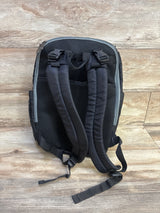 Back view of Fisher-Price Kaden FastFinder diaper backpack showing padded mesh back and adjustable straps on wood floor