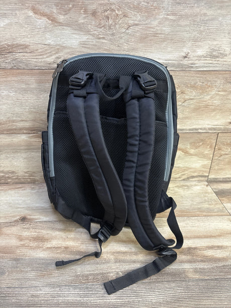 Back view of Fisher-Price Kaden FastFinder diaper backpack showing padded mesh back and adjustable straps on wood floor