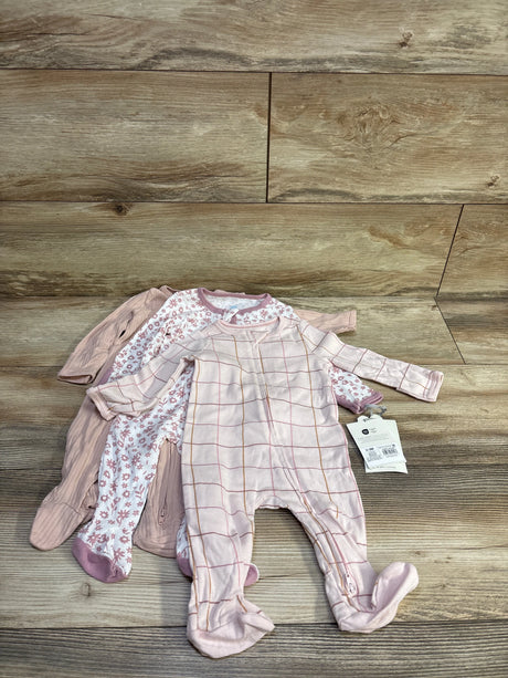 Front view of three Cloud Island footed sleepers (0–3M) showcasing pink grid, white floral, and solid ribbed styles on wood
