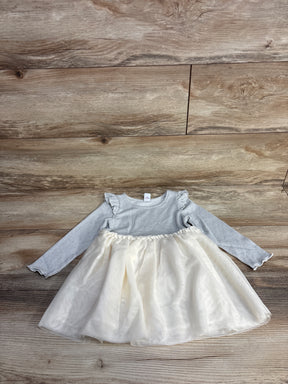 Long-sleeve gray toddler dress with ruffled shoulders and cream tulle skirt on wood floor