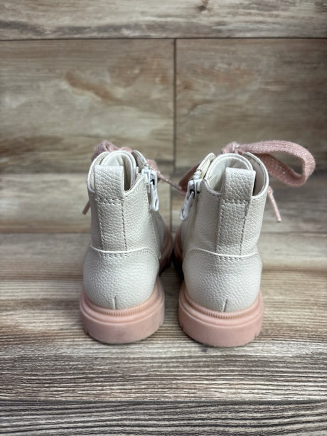 Rear view of Cat & Jack Amaya combat boots showcasing ivory textured uppers, pink laces and soles on a wood surface