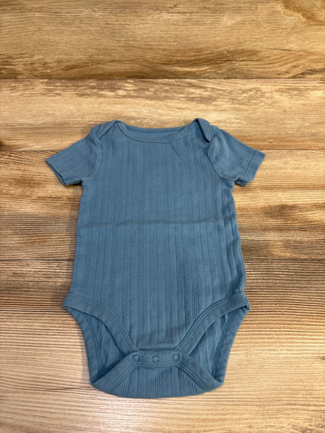 Flat lay of Cloud Island ribbed blue bodysuit size 12 months with short sleeves and three-snap crotch on wood background