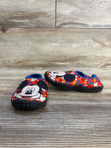 Mickey Mouse toddler shoes with red print, blue trim, non-slip soles on wood floor