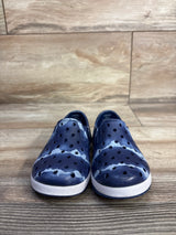 Front view of Cat & Jack Jese slip-on water shoes showcasing perforated blue tie-dye upper and white textured sole on wood floor background