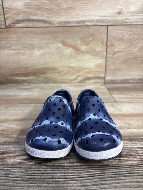Front view of Cat & Jack Jese slip-on water shoes showcasing perforated blue tie-dye upper and white textured sole on wood floor background