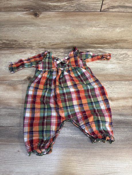 Plaid long sleeve baby romper in red, green, and orange on wood background