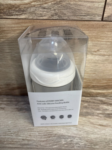 Perry Mackin anti-colic silicone baby feeding bottle in clear packaging on wooden surface