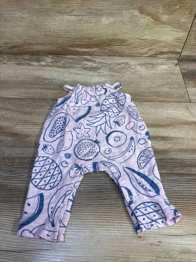 Flat lay of newborn pink Cat & Jack jumpsuit showing blue fruit print and leg snap closures on wood floor