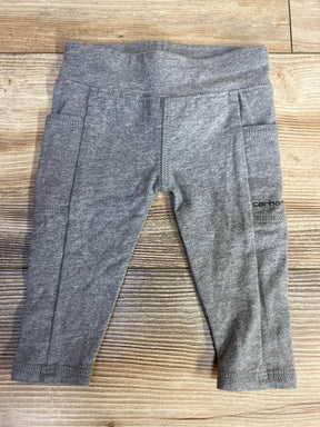 Grey toddler leggings with pockets and Carhartt logo on wooden surface