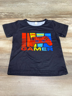 Flat-lay of black toddler t-shirt (2T) showing red game controller graphic and the words ONE MORE TIME GAMER on a wood surface