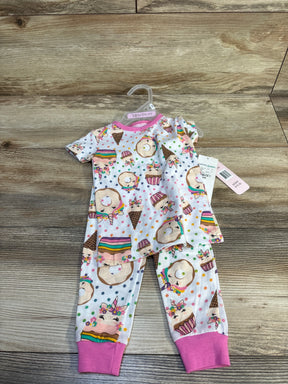 Kids' unicorn-themed pajama set with donuts and cupcakes, pink cuffs, on wooden floor