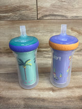 Front view of two The First Years Bluey insulated straw cups (2-pack) showing teal/purple and lavender/orange lids on a wooden tabletop