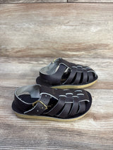 Side view of Salt Water Sun-San brown sandals size 7C showing woven straps, buckle and crepe sole on wood background