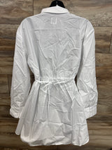 White maternity shirt dress with tie waist, long sleeves, and button cuffs on mannequin