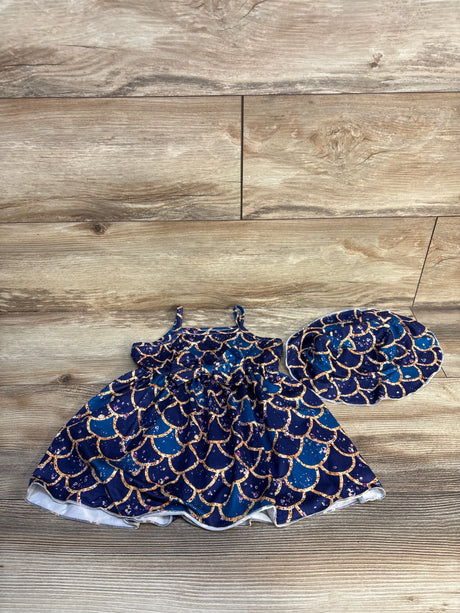 Navy blue toddler dress and matching hat with gold mermaid scale pattern on wood floor
