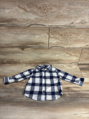Blue and white plaid long sleeve toddler shirt on wood floor