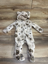 Soft baby fleece onesie with bear faces print and hood featuring bear ears, laid flat on wood floor