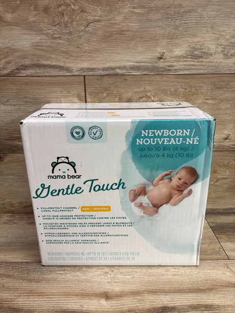 Front view of Mama Bear Gentle Touch newborn diapers showcasing 120 diapers and up to 10 lb size with a wood background