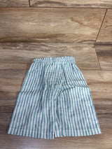 Front view of toddler blue-and-white striped Mayoral pants with elastic waistband on wood floor background