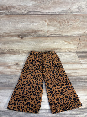 Flat lay of girls' Cat & Jack brown leopard print wide-leg jeans showing elastic waistband and wide flared legs on light wood floor
