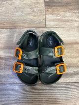 Top view of Cat & Jack kids camo footbed sandals showcasing two adjustable straps with bright orange buckles on wood floor