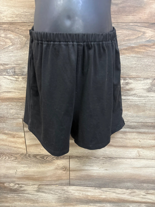 Front view of Ekouaer maternity lounge shorts showcasing an elastic waistband and loose fit with a wood floor background