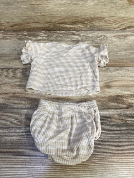 Flat lay of newborn ribbed two-piece shirt and bloomers showing ivory thin stripes and ruffled sleeves on wood background