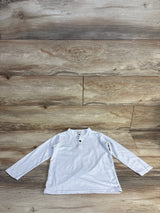 Long sleeve white henley shirt for kids with buttons, displayed on wood background