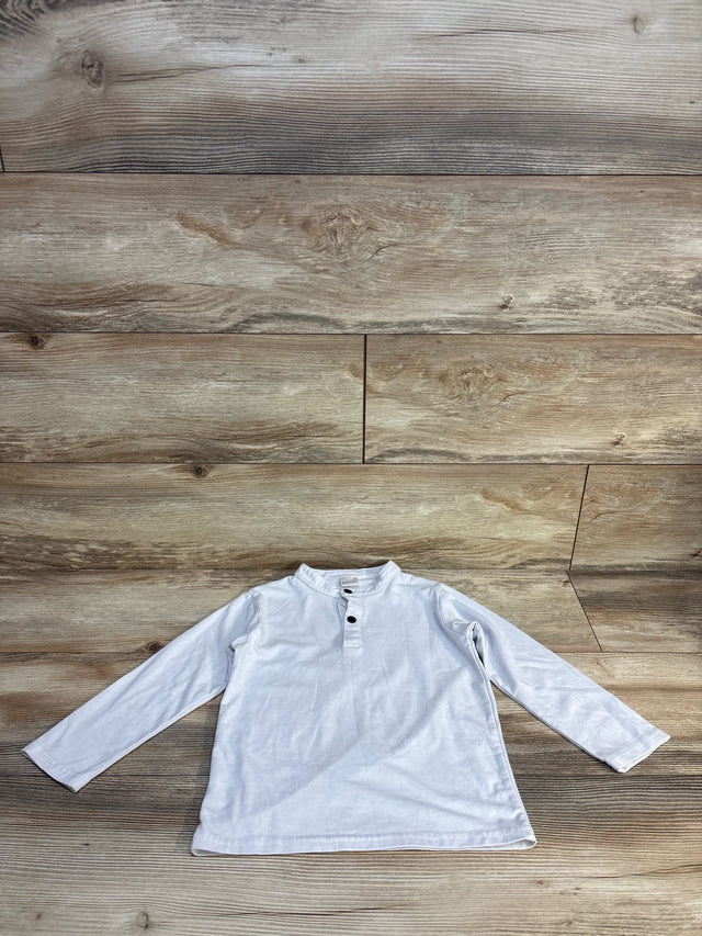 Long sleeve white henley shirt for kids with buttons, displayed on wood background