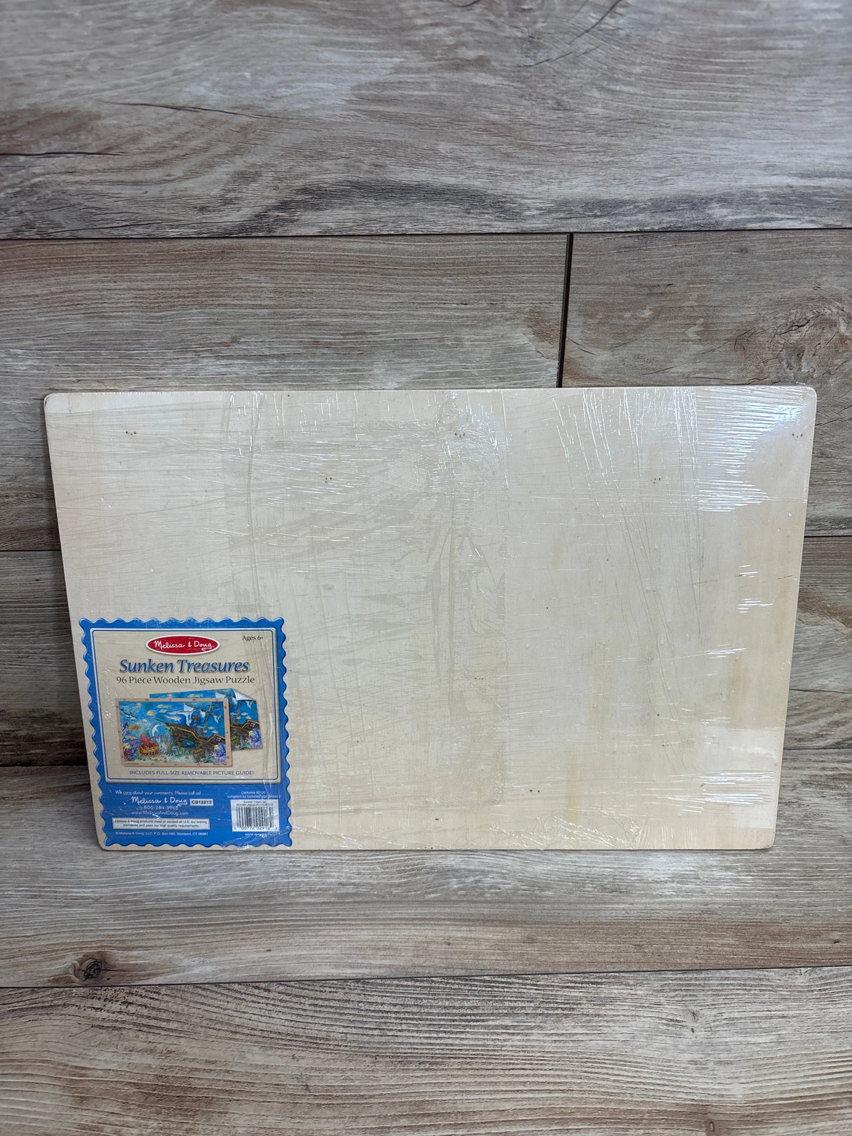 Melissa & Doug Sunken Treasures 96-piece wooden jigsaw puzzle on wood background
