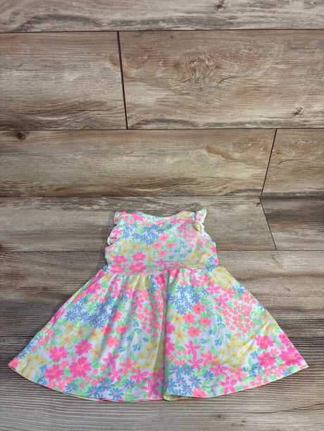 Flat lay of girls Freestyle floral dress showing ruffled cap sleeves and full gathered skirt on wooden floor