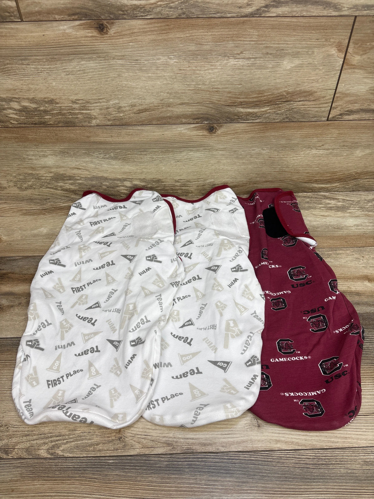 Three South Carolina Gamecocks swaddle wraps, including two white patterned wraps and one maroon team-logo wrap, size 6/9 months