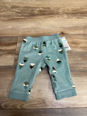 Soft teal baby pants with tree pattern on wood floor, resale kids clothing