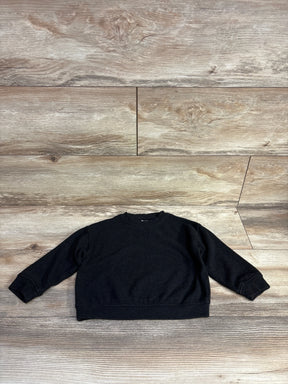 Black long sleeve toddler sweatshirt on wood background, kids clothing resale.