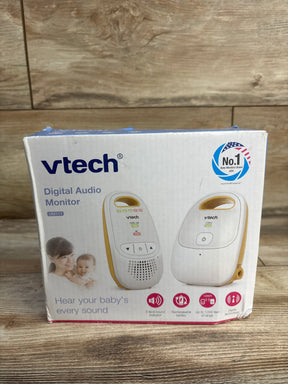 Front of VTech DM111 baby monitor box showing the units and headline Hear your babys every sound on wooden surface