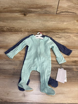 Two ribbed baby footed pajamas in mint green and navy blue on wood floor