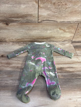 Flat lay of Nike baby footed sleeper, size 3 months, showing green tie-dye with pink and white splashes on wood background