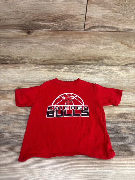 Front view of red Chicago Bulls toddler shirt showcasing bull logo and Chicago Bulls graphic on a wood floor