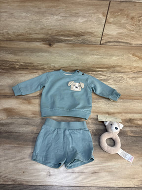 Baby boy outfit with dog appliqué sweater and shorts, plus plush teether toy on wood floor