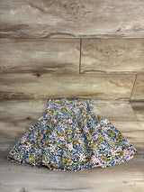 Girls smocked floral dress with blue, pink, and green print on wood background