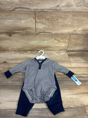 Striped long sleeve baby romper navy blue and white with button front, laid on wood floor