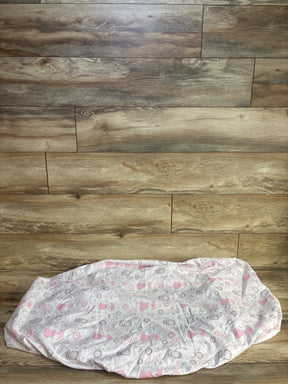 Front view of Peanutshell fitted crib sheet showing pink and gray fox and owl pattern on white, laid flat on wood background