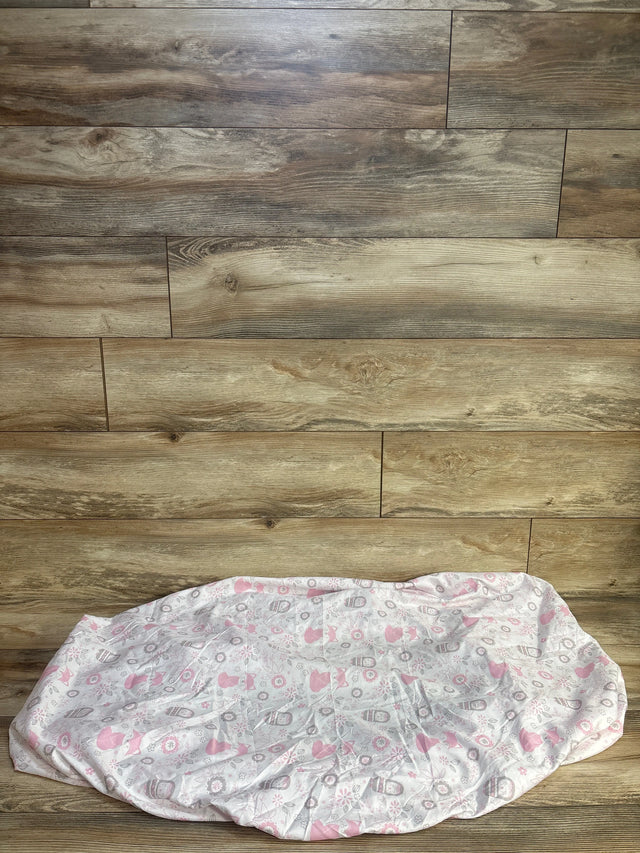 Front view of Peanutshell fitted crib sheet showing pink and gray fox and owl pattern on white, laid flat on wood background