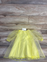 Yellow tulle baby dress with polka dots, long sleeves, laid on wood floor