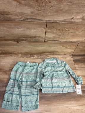 Mint green toddler pajama set with snowflake pattern, long sleeves and pants on wood floor