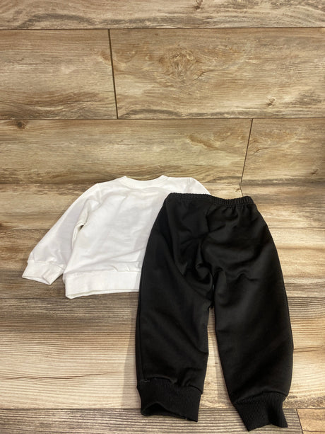 Overhead view of Shein Coolqubz All New Things set showing white sweatshirt and black pants, size 18 to 24 months, on wood backdrop