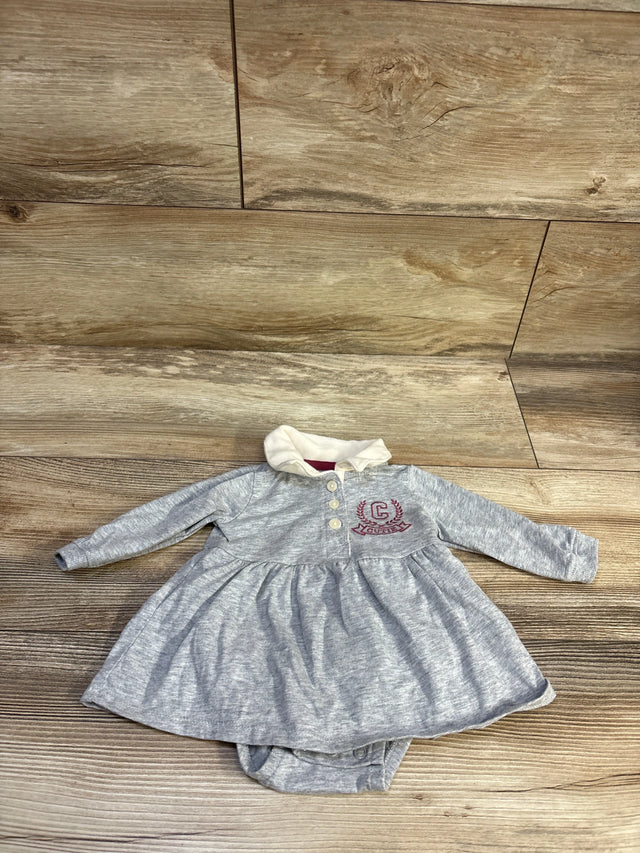 Front view of Carter’s grey polo bodysuit dress, size 3m, with long sleeves, collar, and attached bottom on wood floor