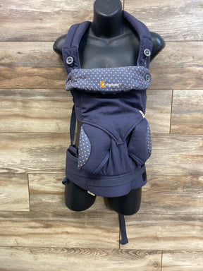 Front view of Ergobaby 360 carrier in dusty blue with padded straps, polka-dot headrest and ergonomic seat on wood background