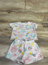 Flat lay gray Paw Patrol two-piece shirt and shorts set with all-over Pup Power print and drawstring waist on wood background
